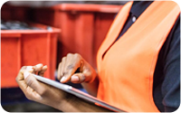 A worker in a manufacturer plant using a tablet