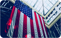 A USA flag hanging in the atrium of a building.